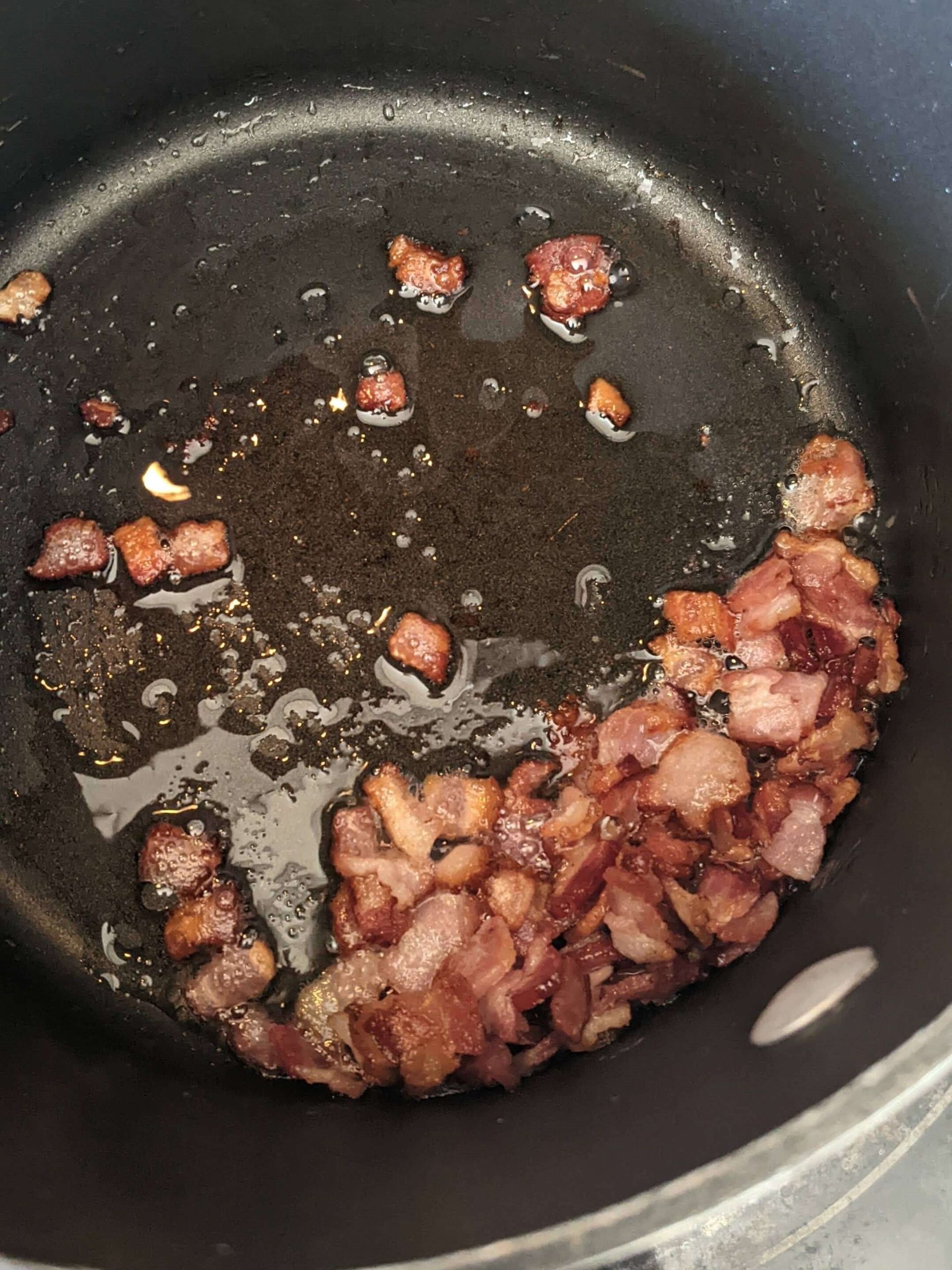 bacon sauteing in a pot