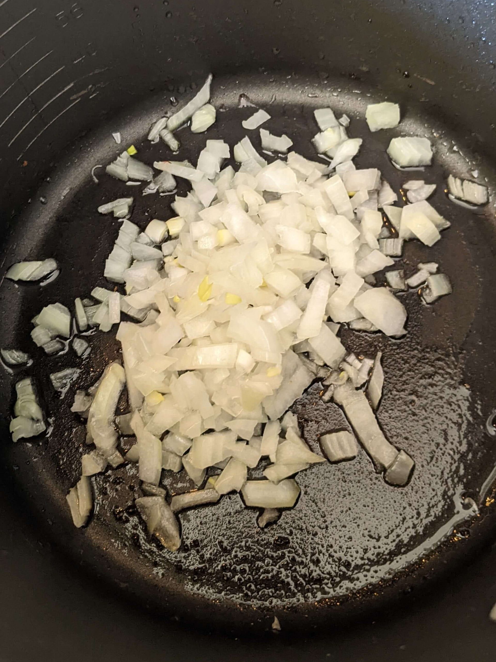 raw onions beginning to cook in a pot
