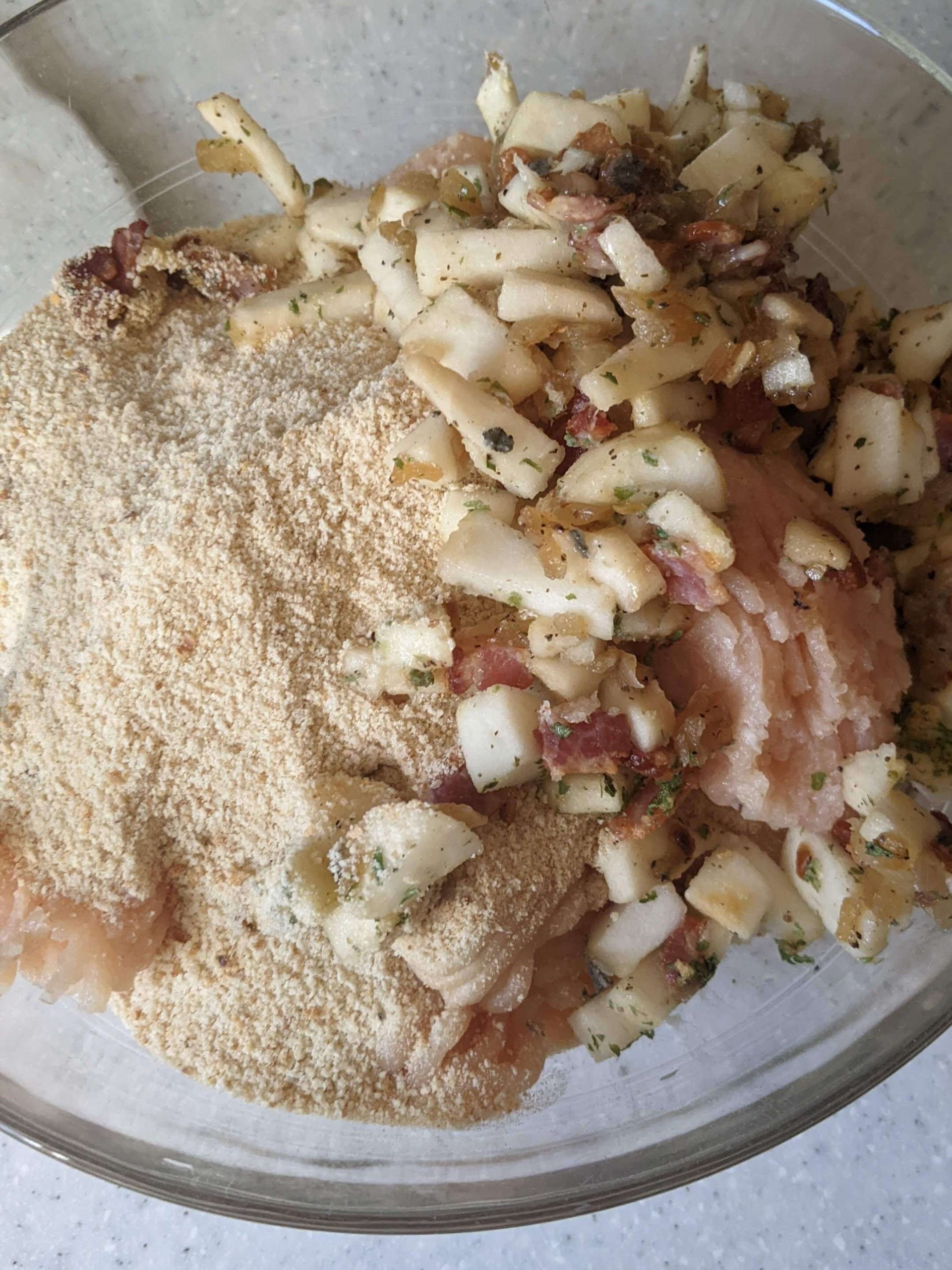 ground chicken in a bowl with apples and bread crumbs