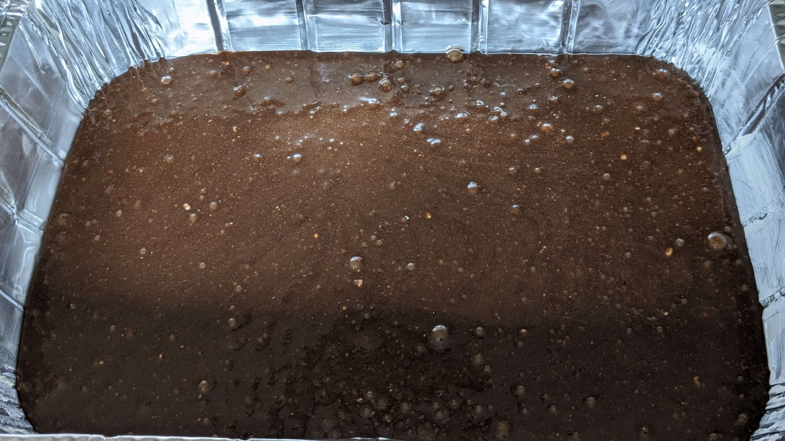 brownie batter in an aluminum pan