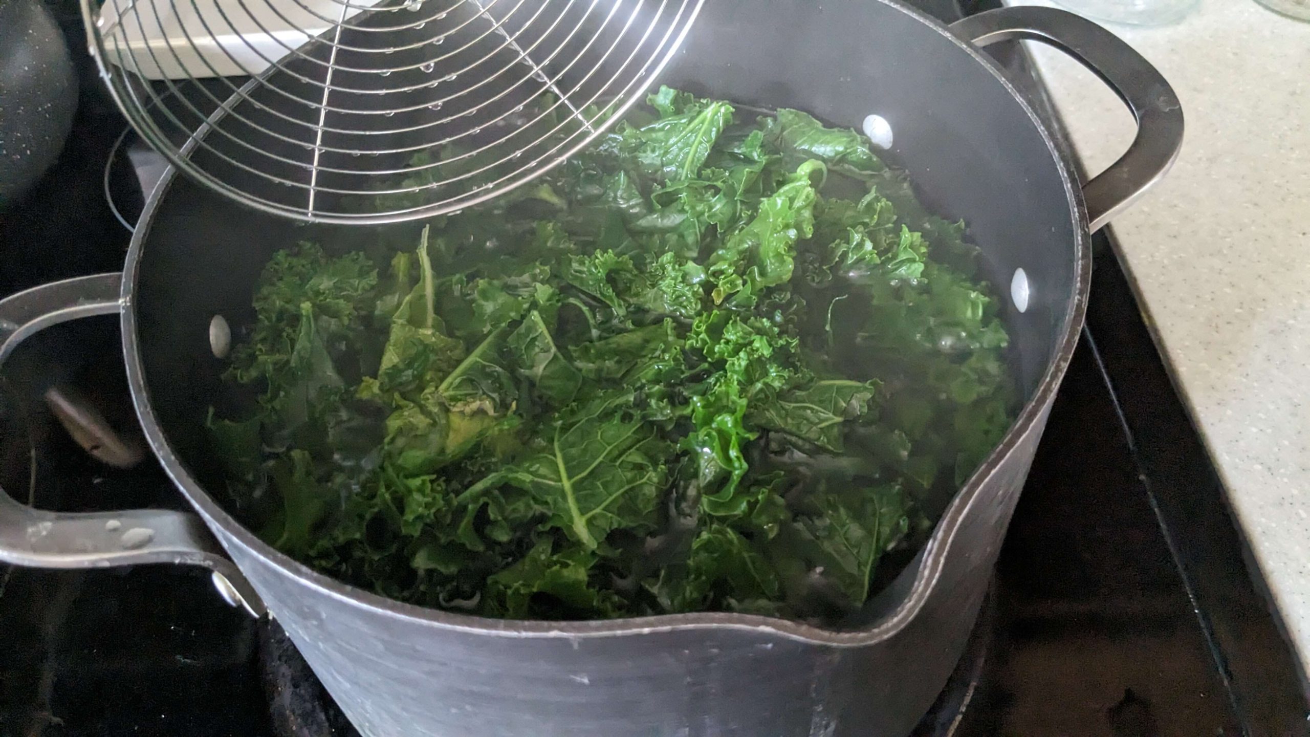 kale blanching in a pot of boiling water