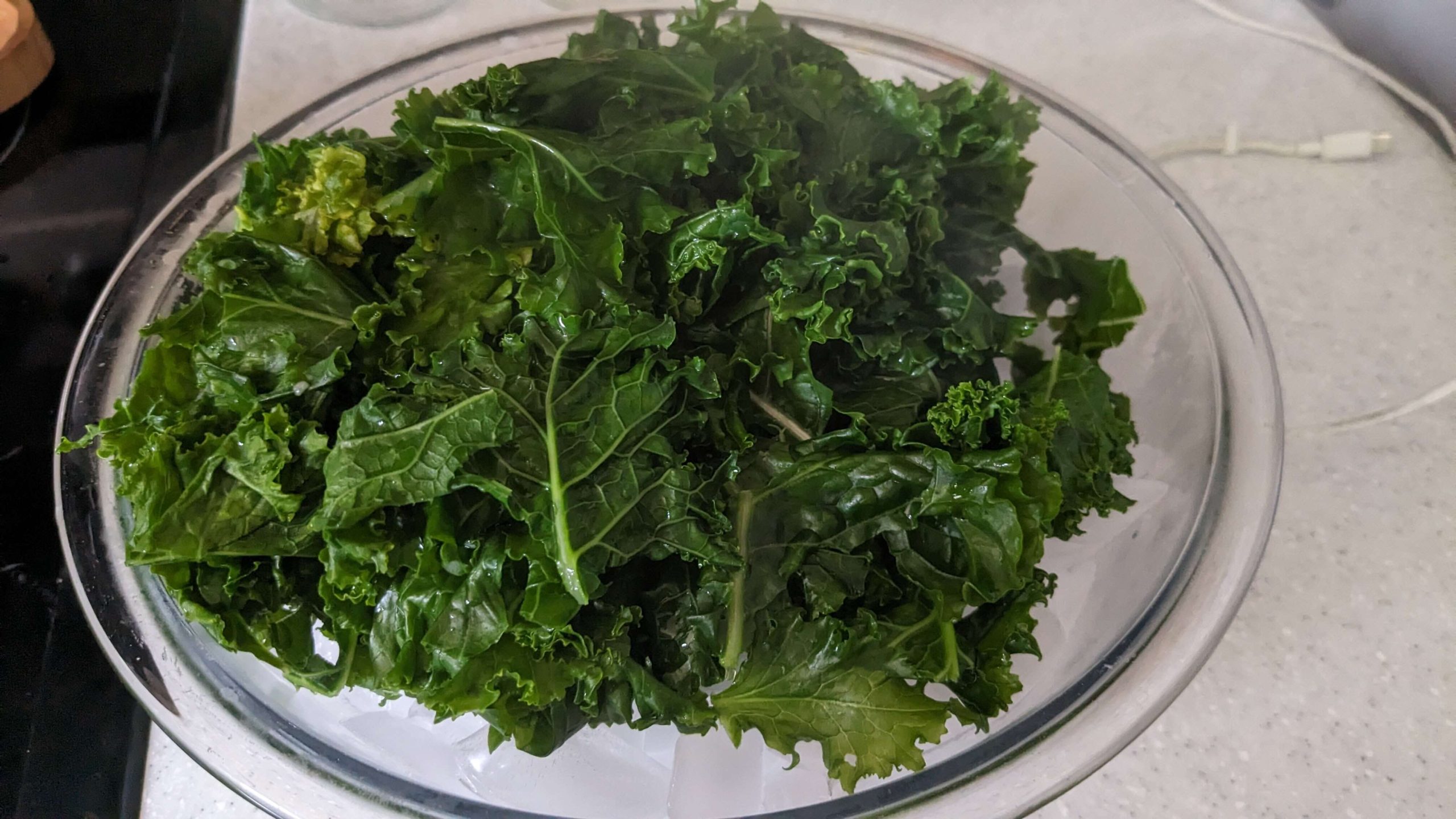 wet blanched kale in a bowl of ice