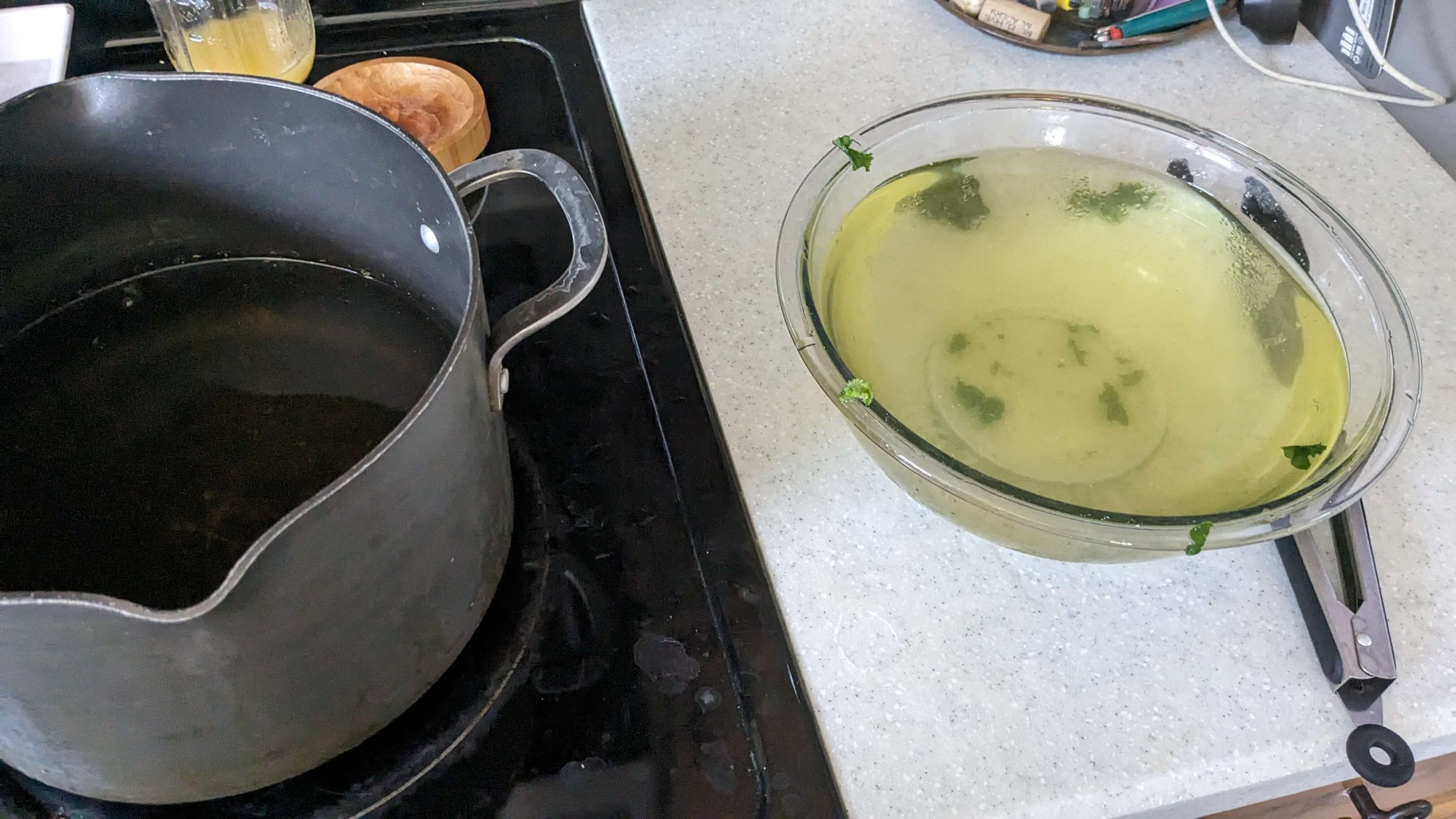 pot with water and a bowl with yellow and green tinted water