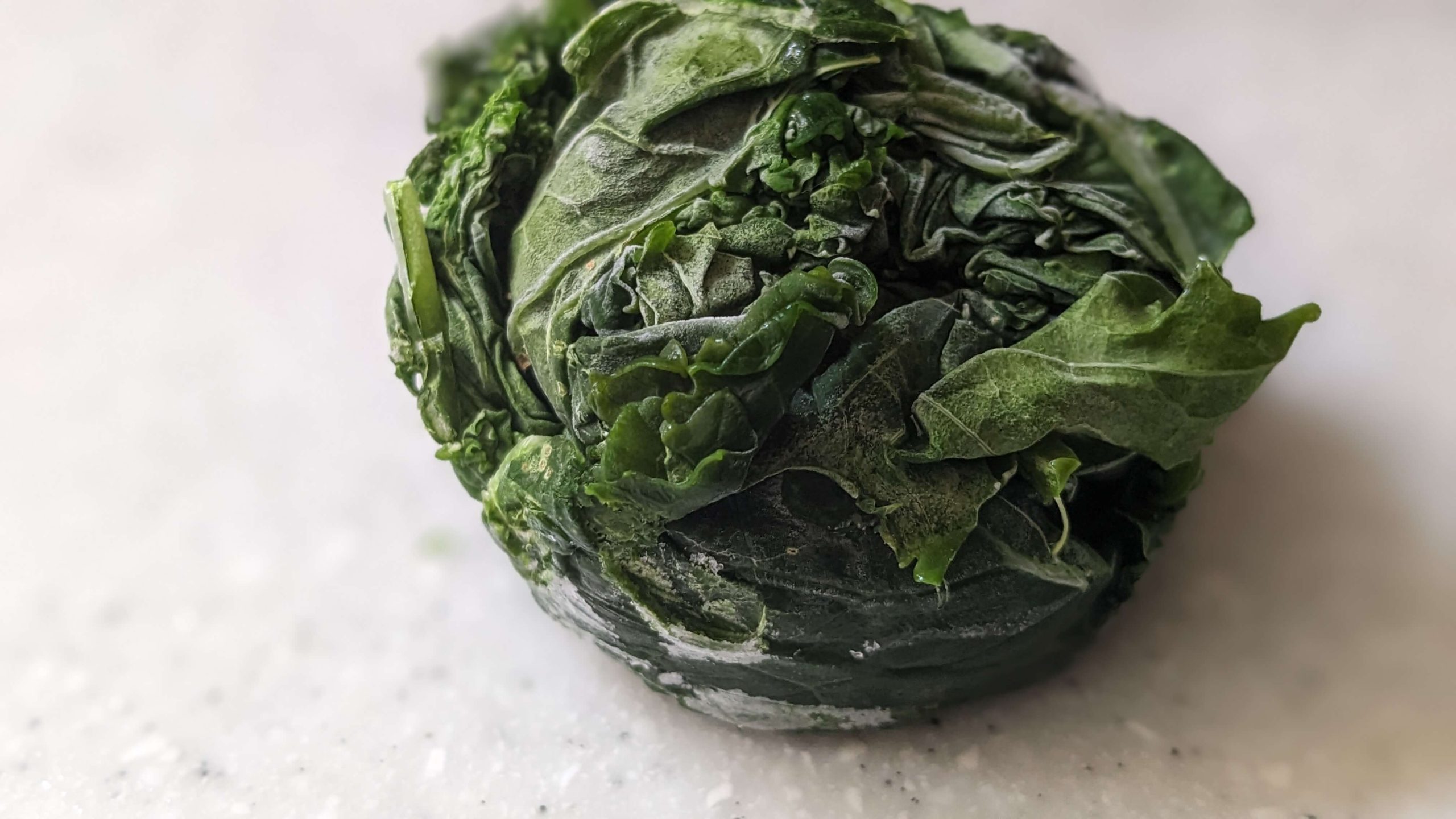 frozen kale in the shape of a muffin tin