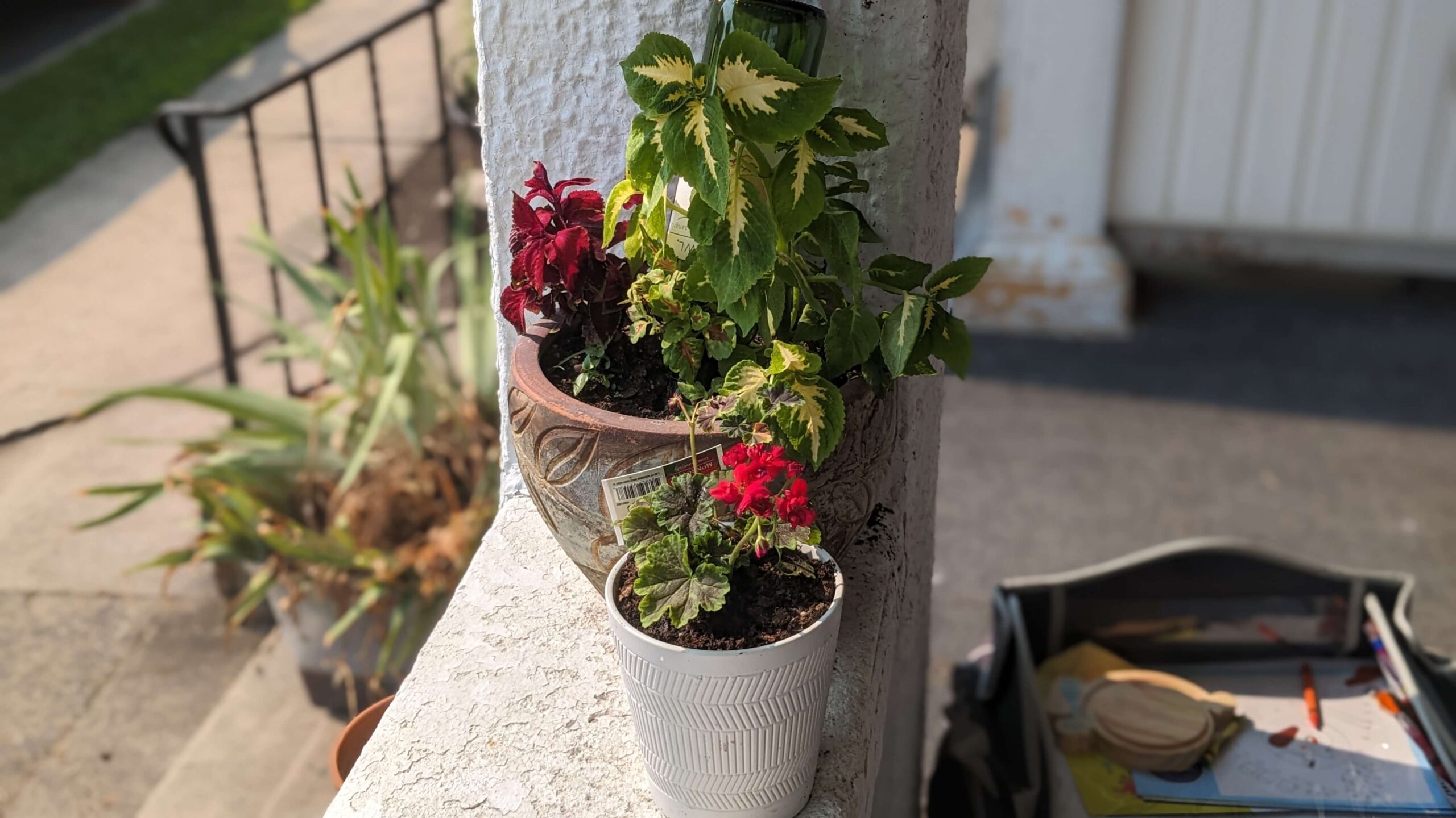 two flower pots on a porch ledge