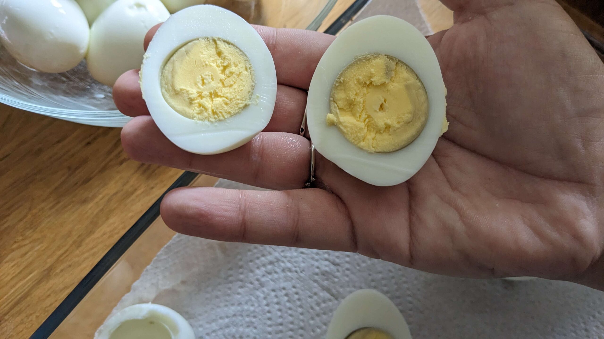 woman holding two halves of a hard boiled egg