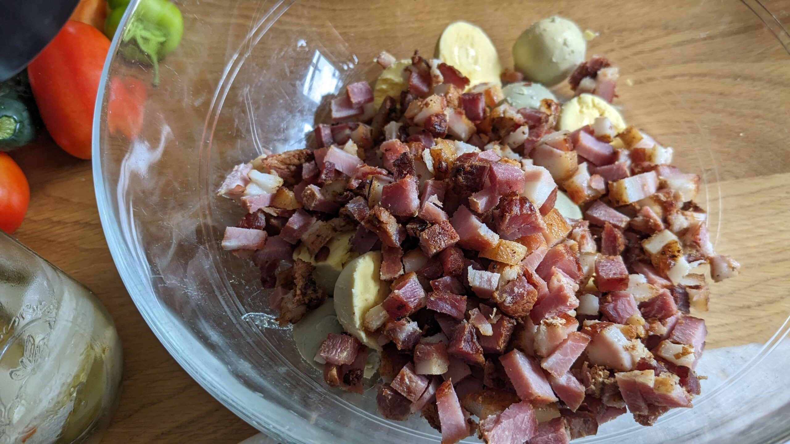 chopped bacon and hard boiled egg yolks in a glass bowl