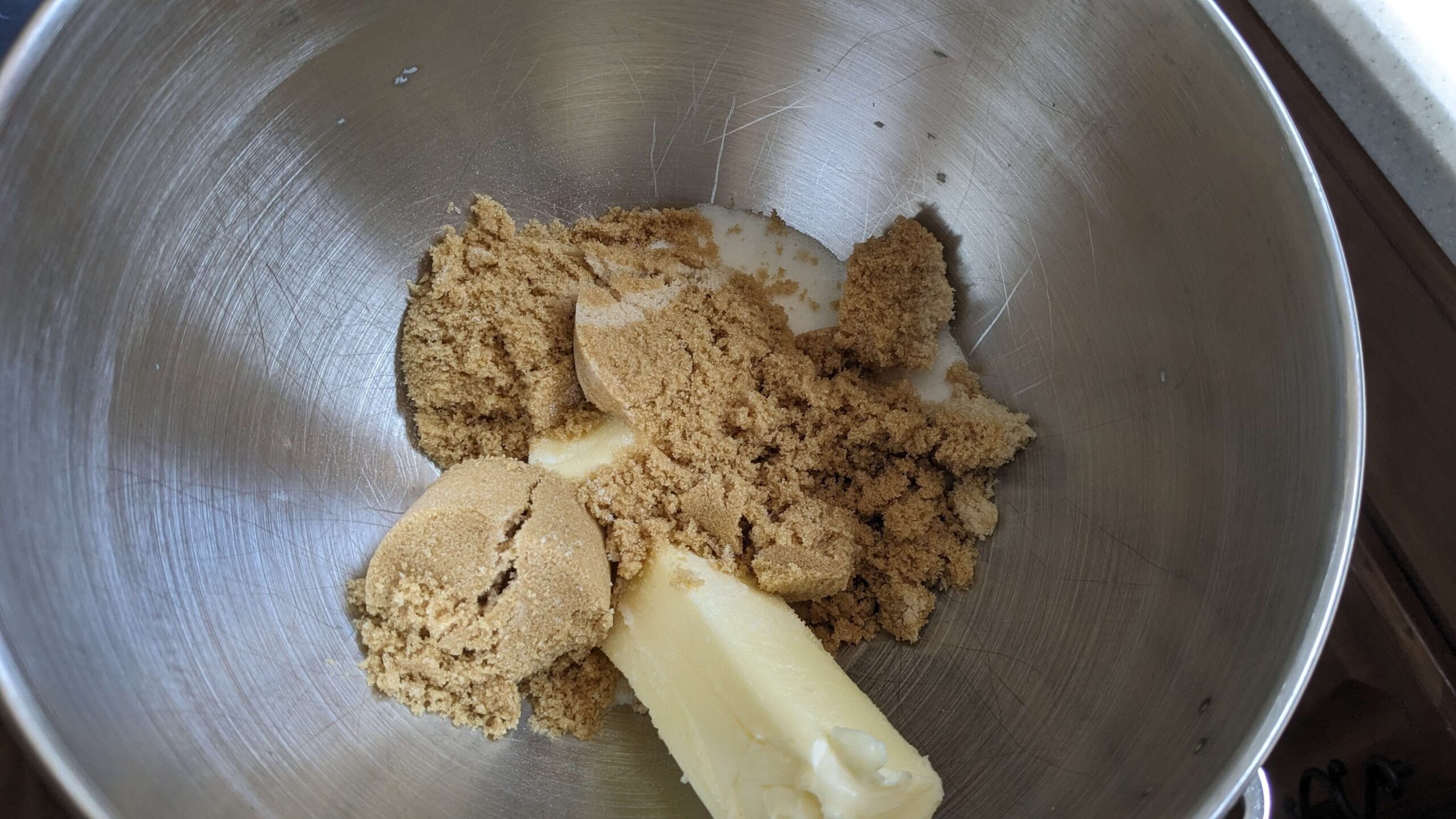 silver bowl with a stick of butter and brown sugar