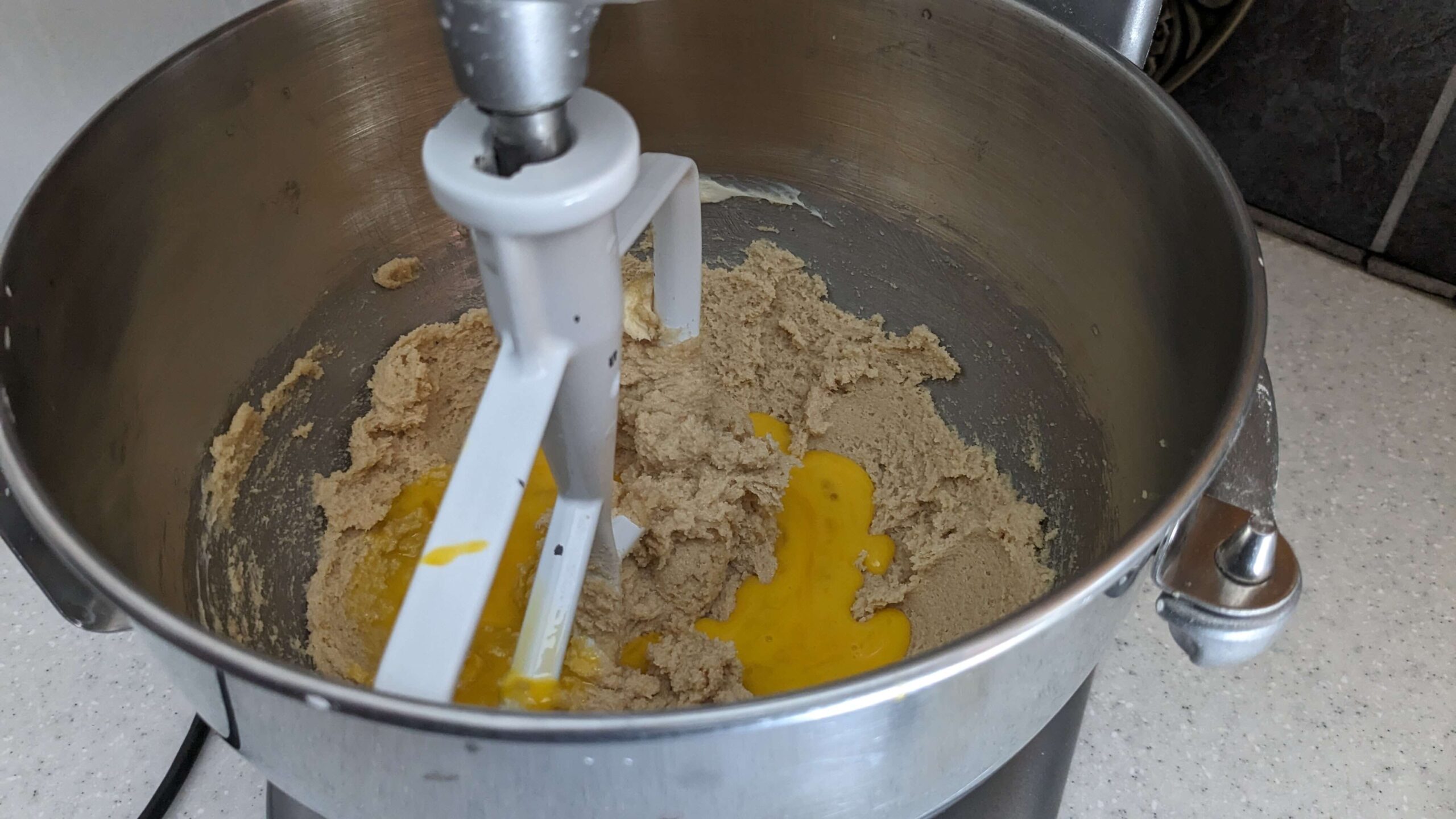 kitchen aid mixer mixing cookie dough and eggs