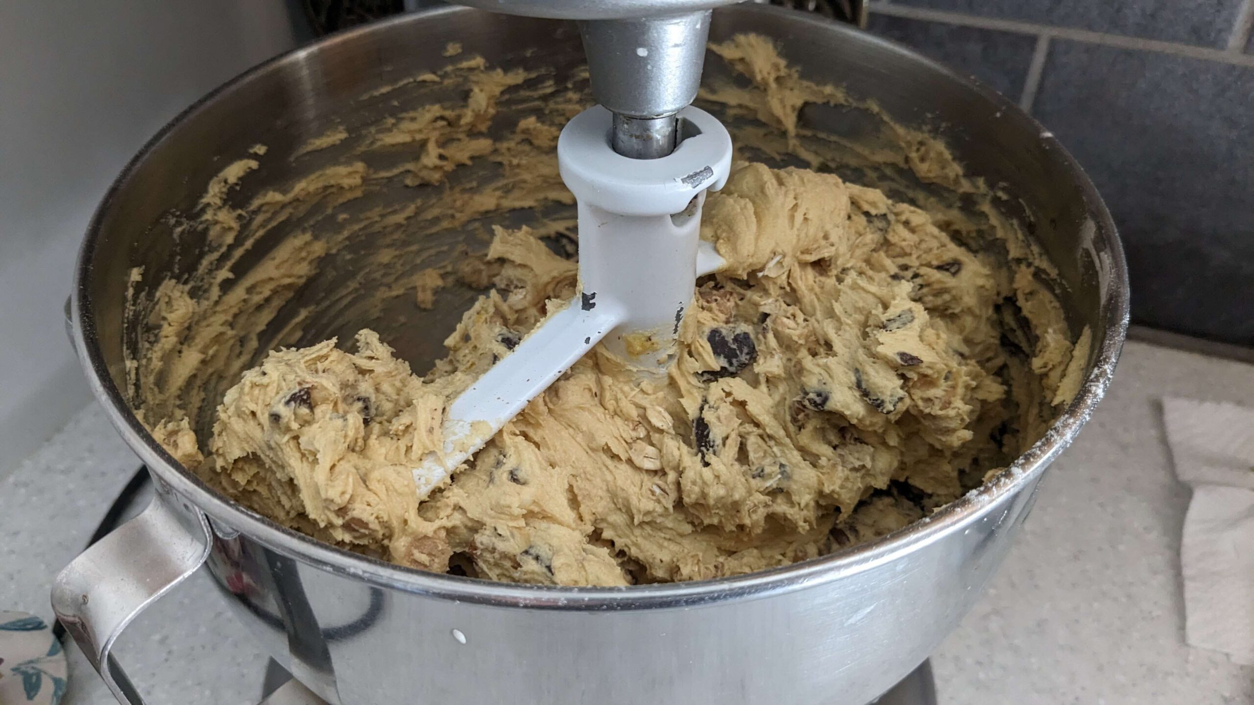 kitchen aid mixing bowl mixing cookie dough with mix ins