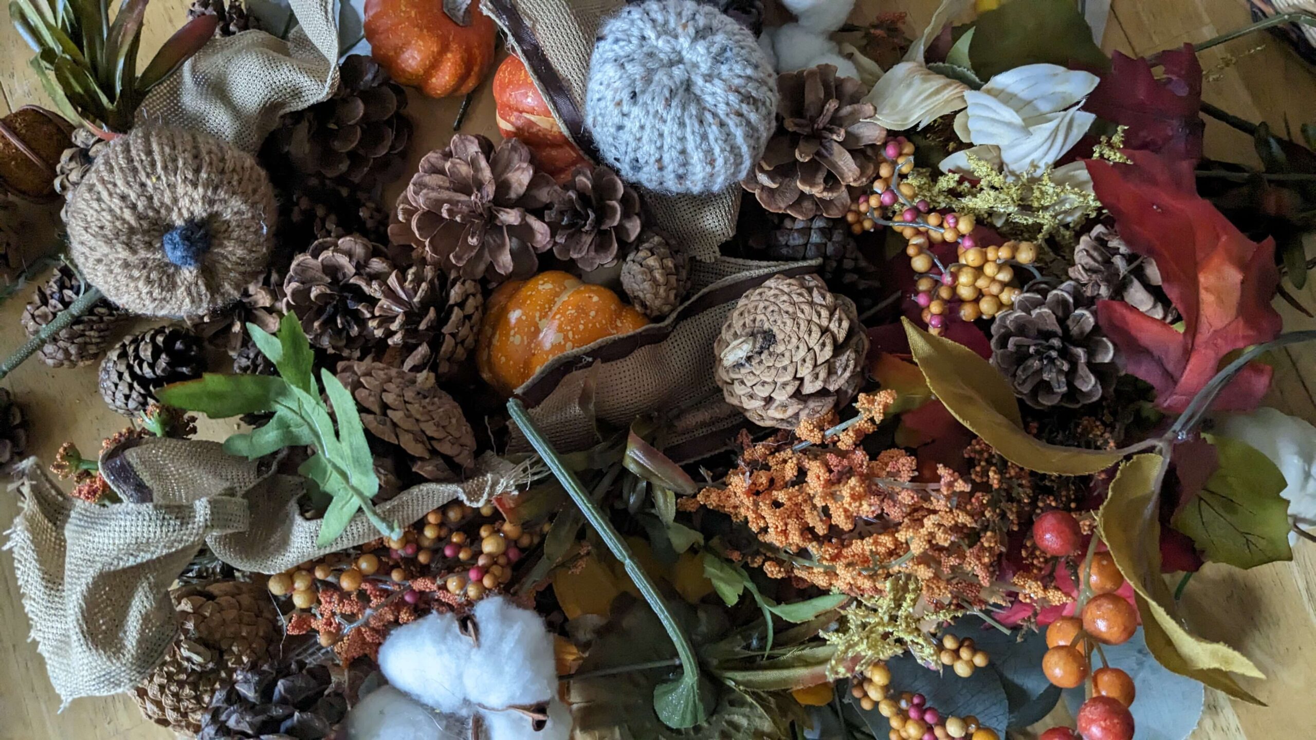 pile of small fall decor, crocheted pumpkins and cotton