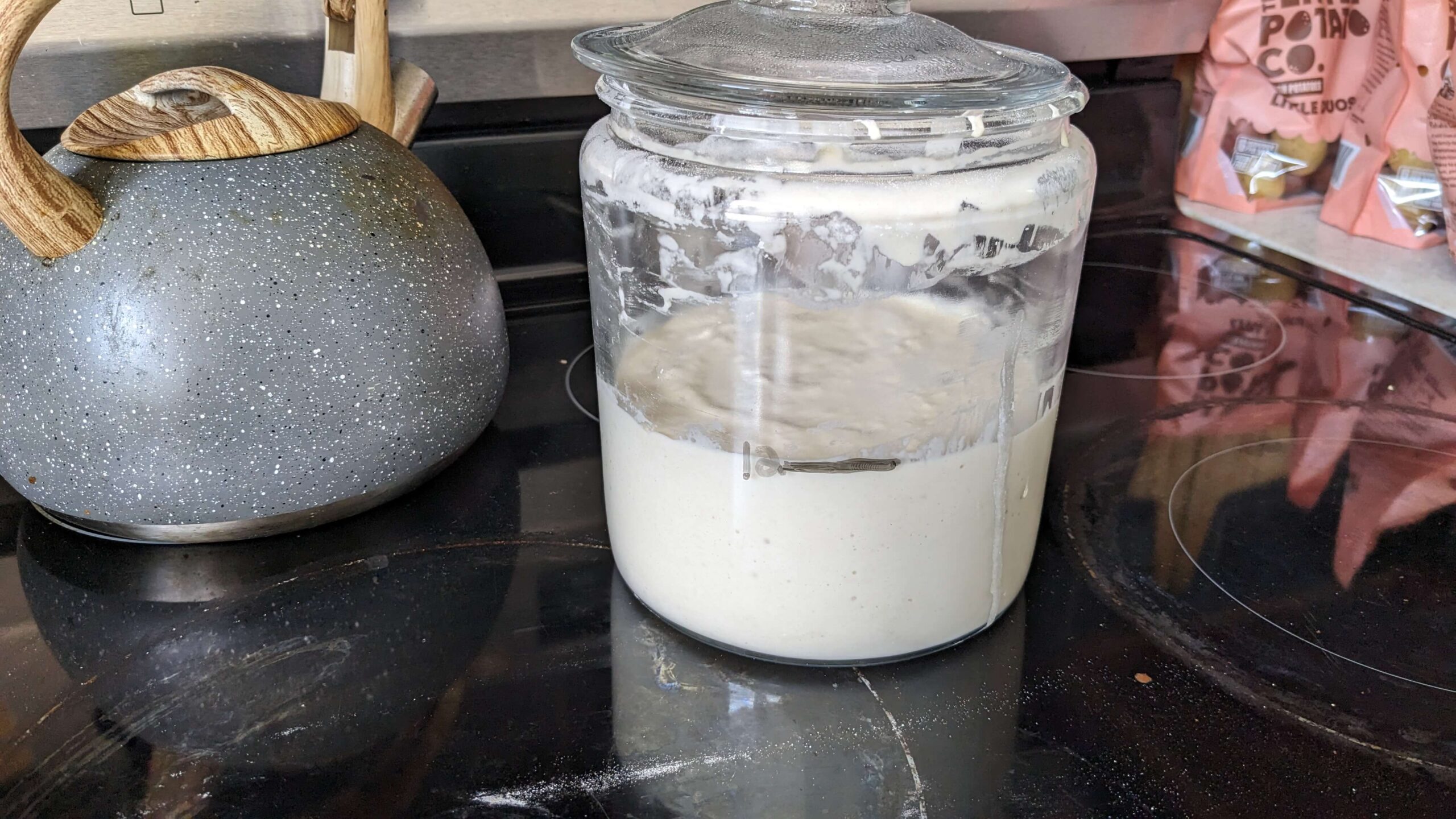 jar of sourdough starter on a stovetop