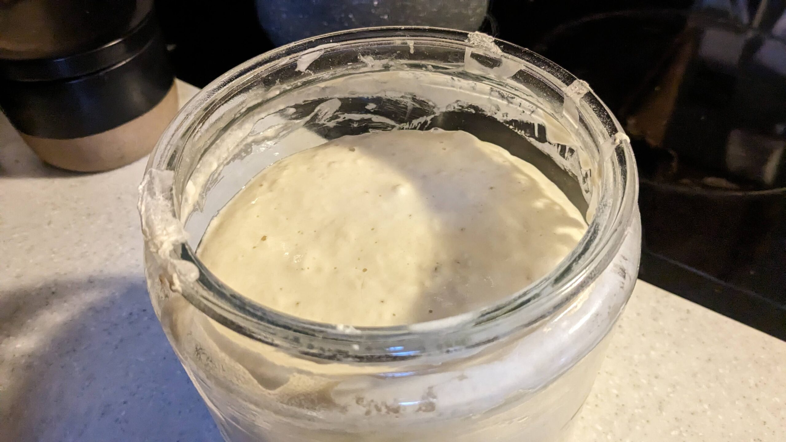 top view of rising sourdough starter in a jar