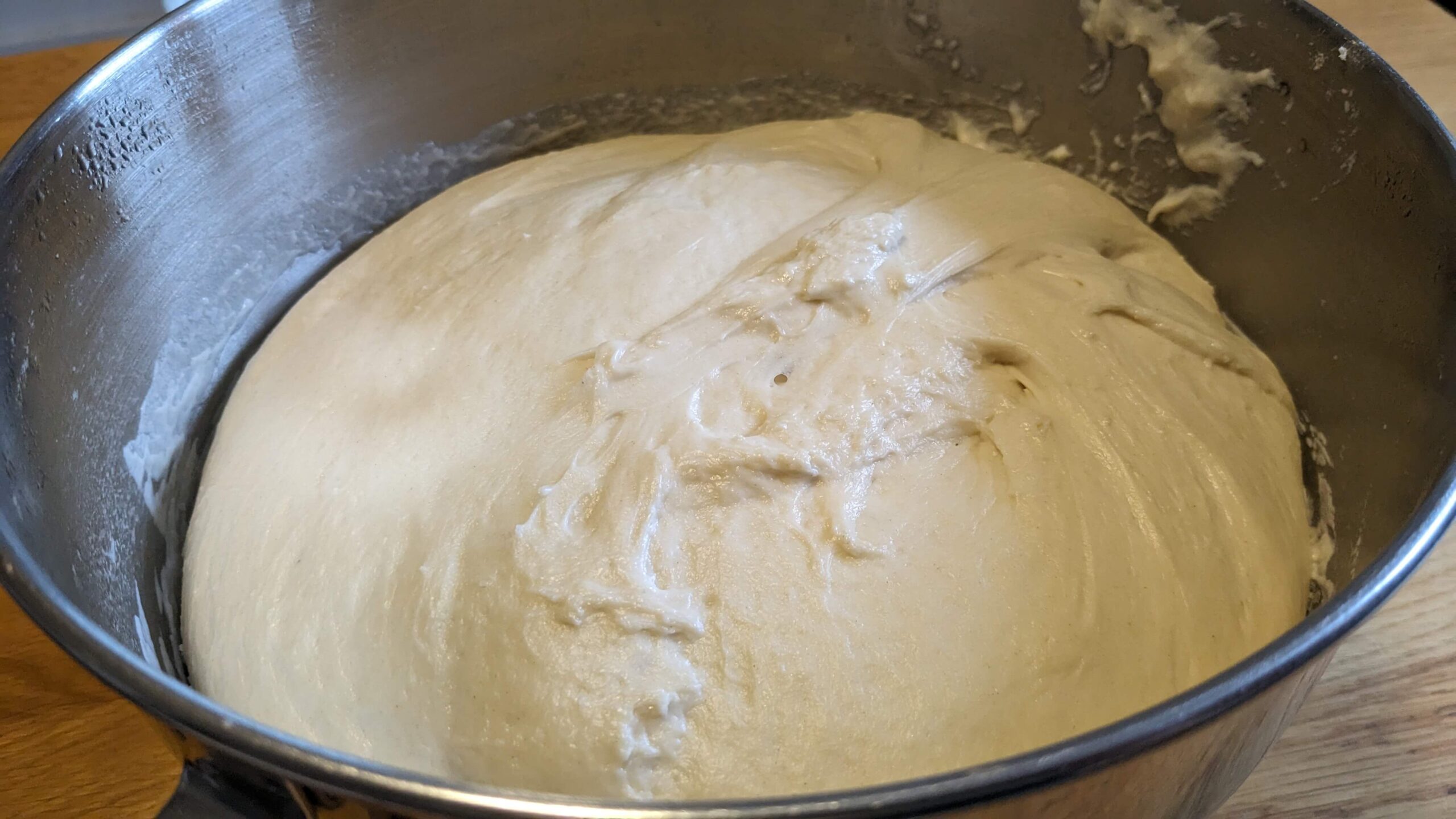 bread dough in a silver bowl