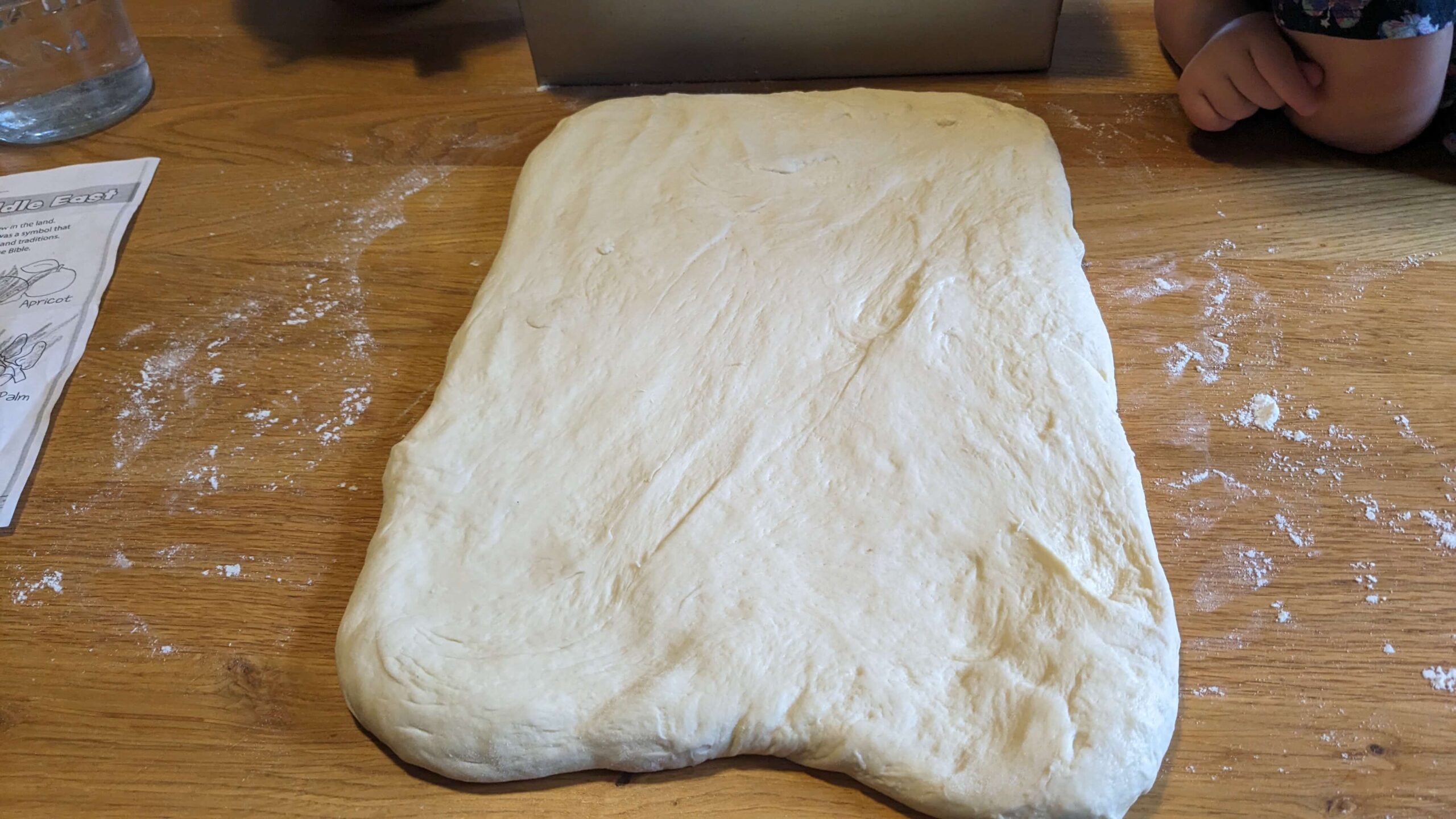 bread dough in the shape of a rectangle on a wooden surface