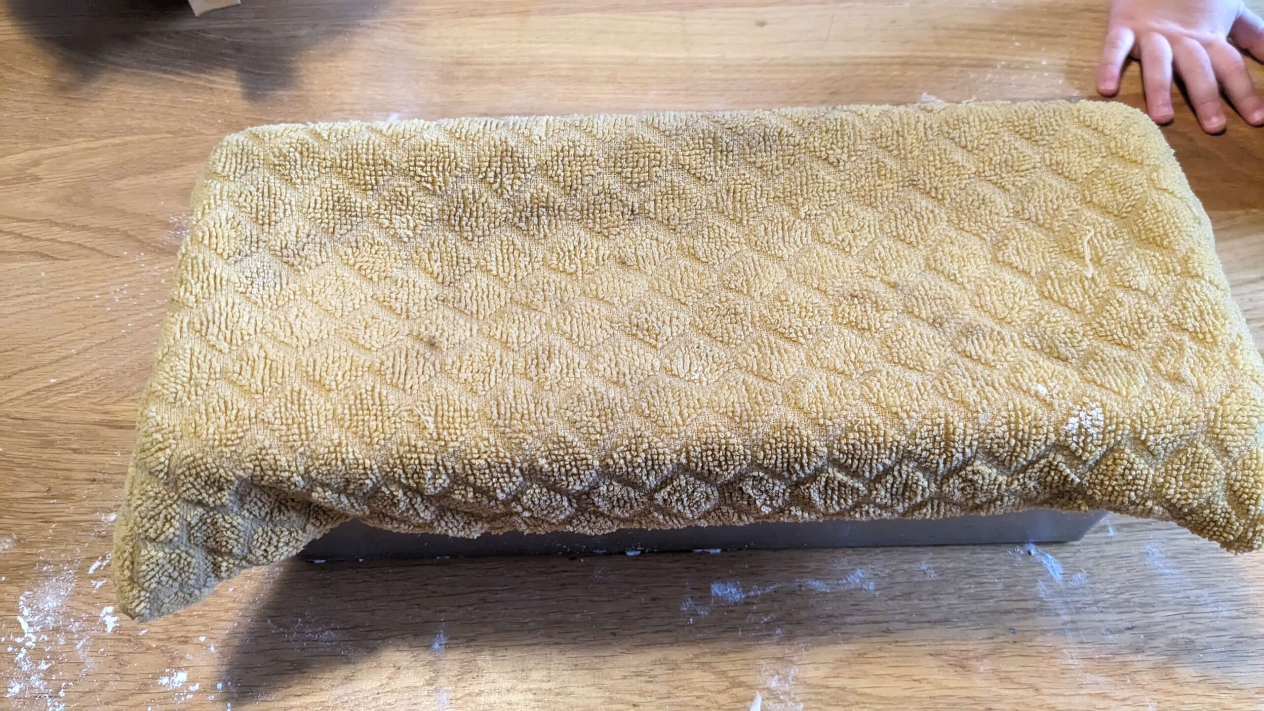 damp yellow towel on a pullman loaf pan