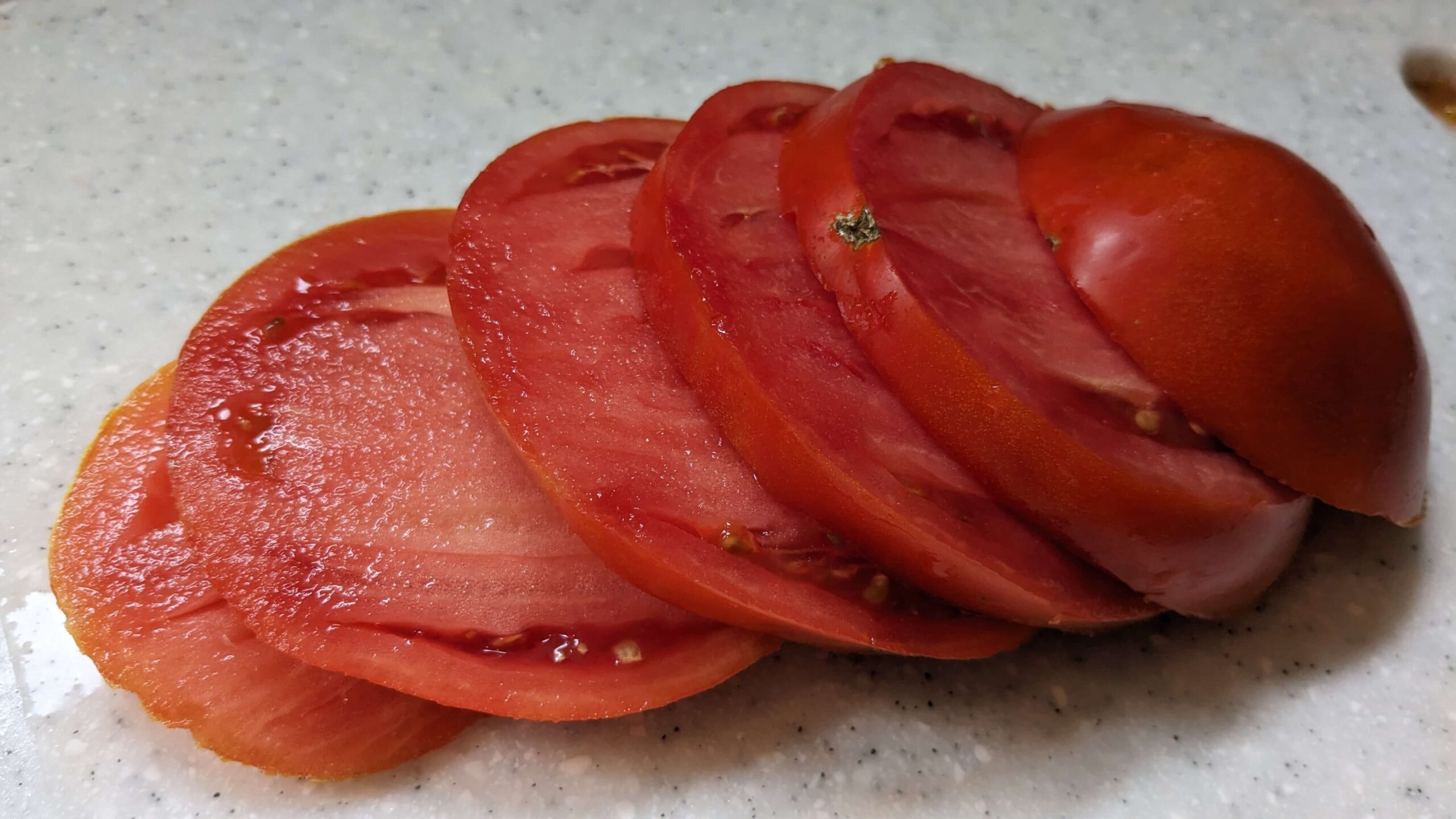 a sliced brandywine red tomato