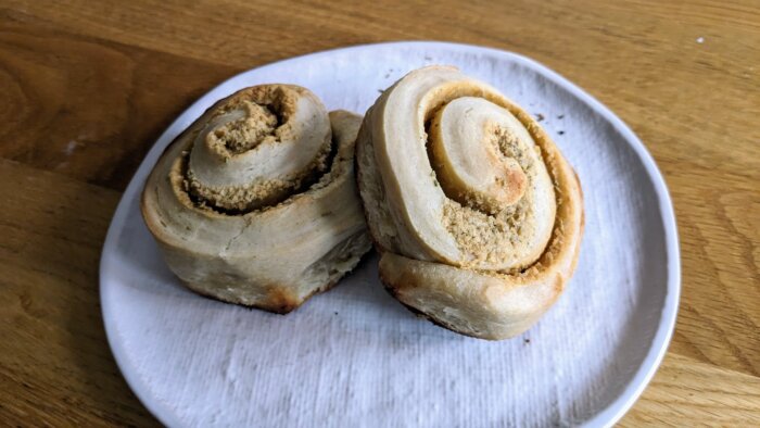 Two garlic rosemary rolls on a white plate