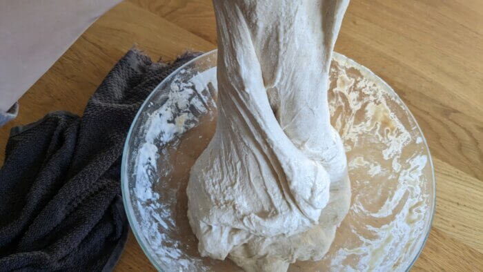 stretching sourdough dough that has been folded on itself