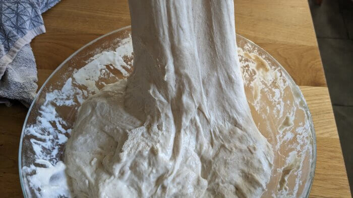 sourdough dough that is being stretched after resting