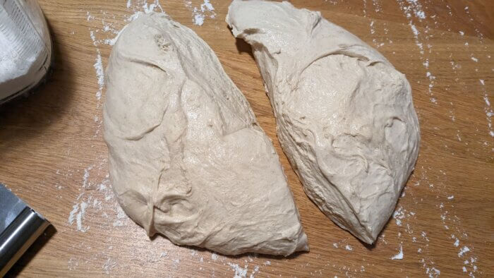 sourdough bread dough that has been cut in half on the counter
