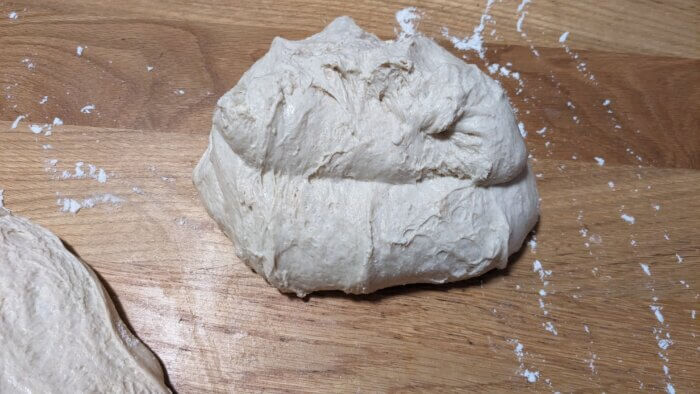 sourdough dough that has been folded onto itself to rest on the counter
