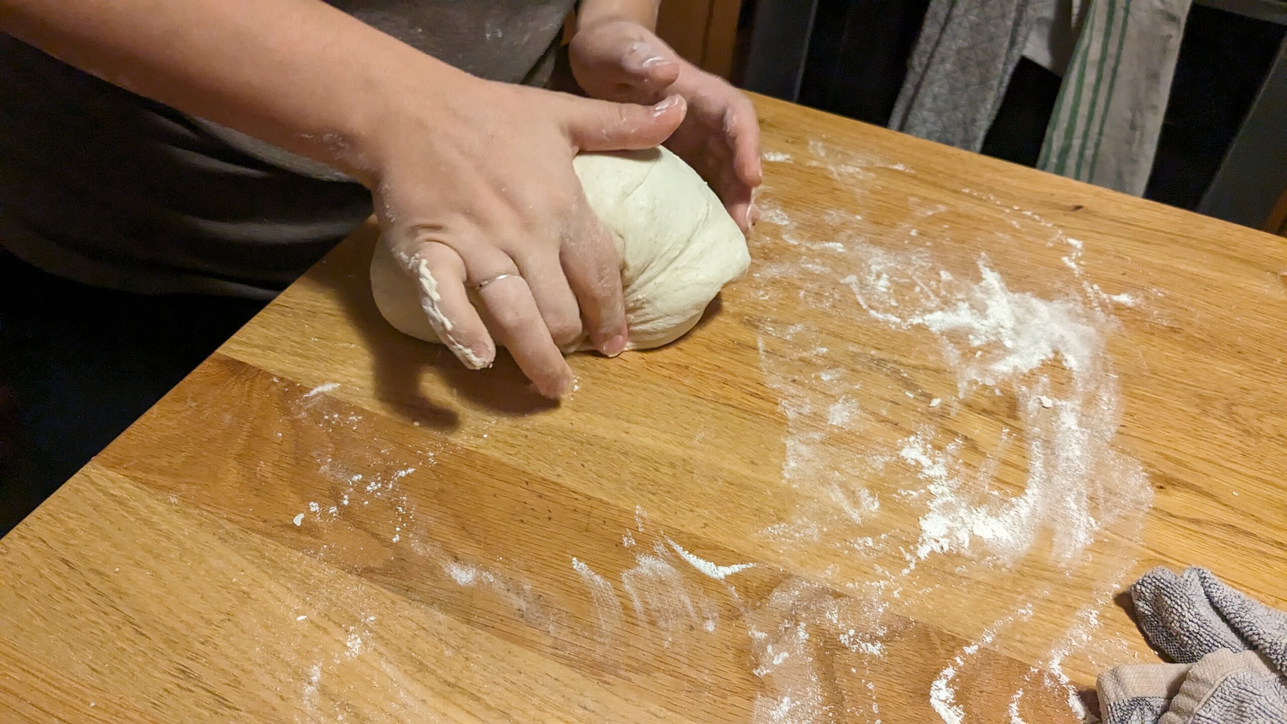 woman tucking sourdough dough into itself