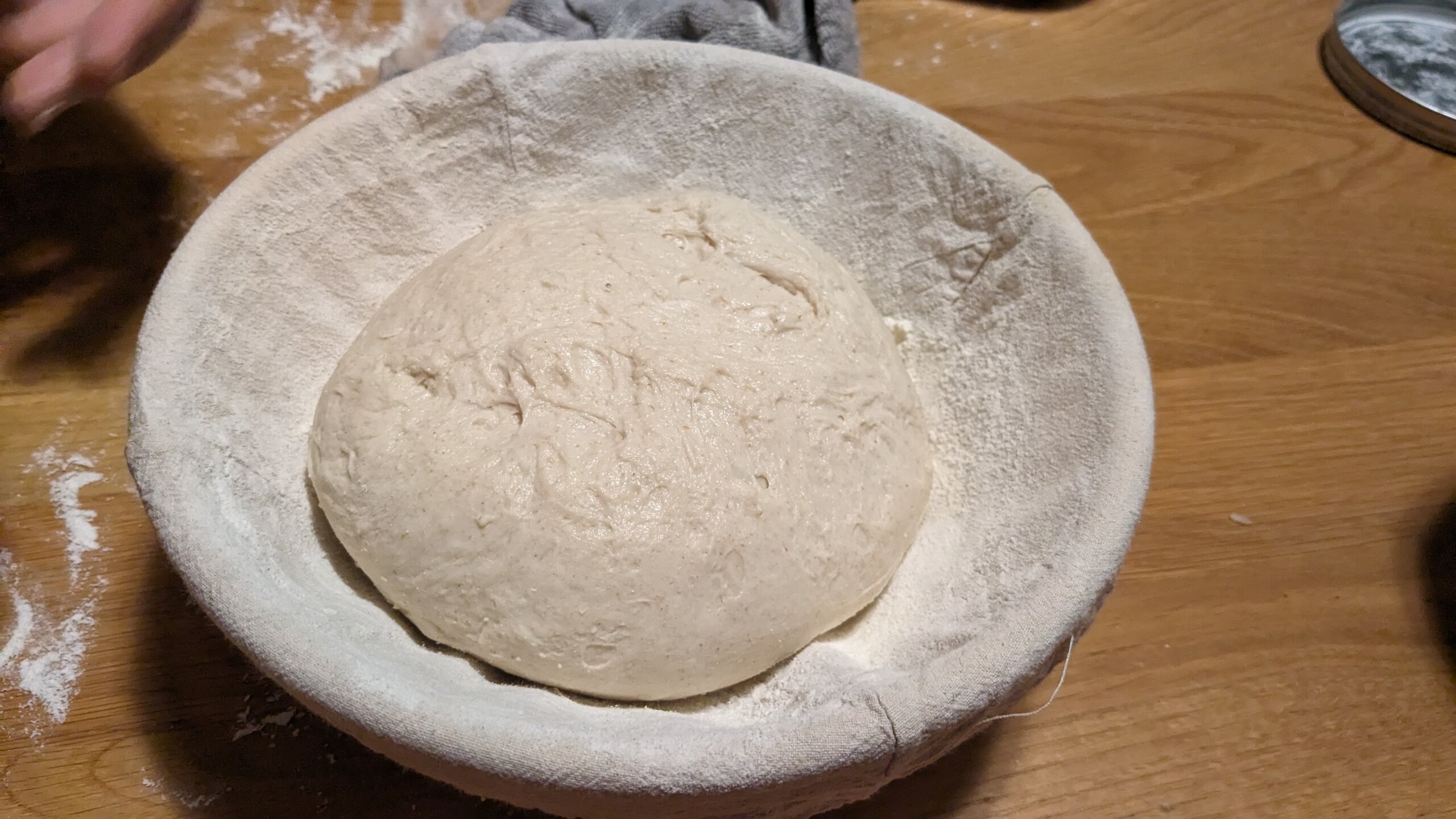 a sourdough boulle upside down in a floured banneton