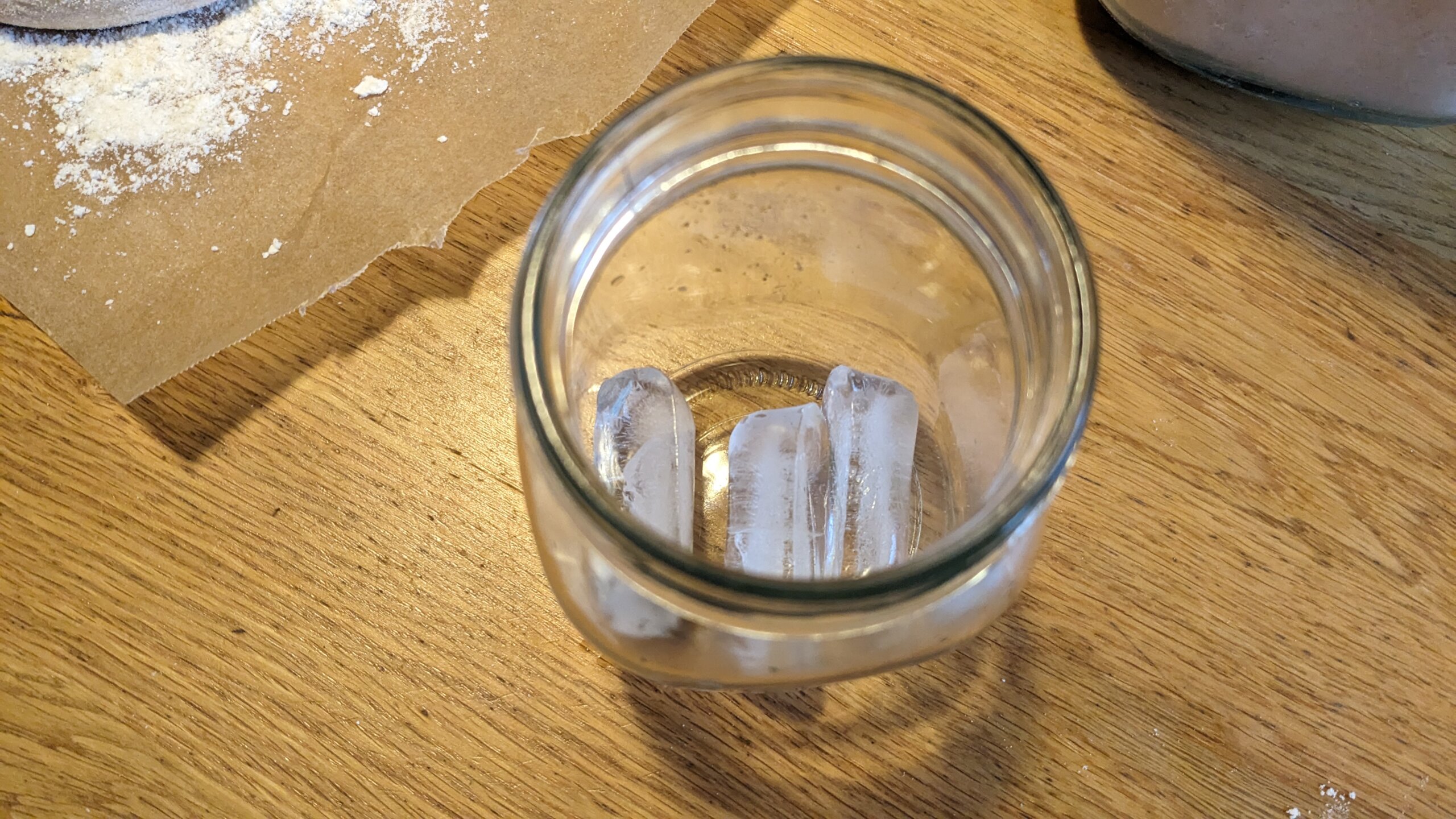 three ice cubes in a mason jar