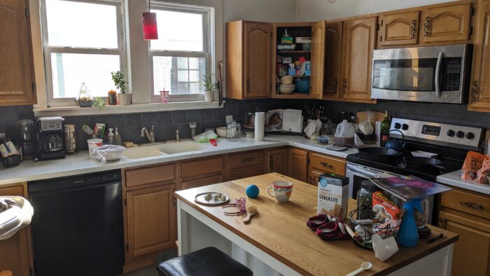 a kitchen with cluttered countertops