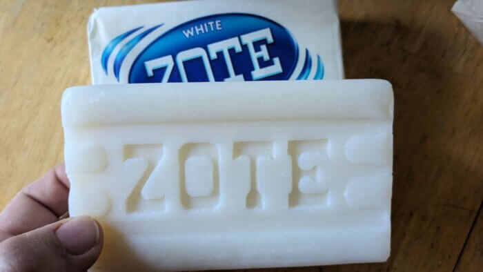 open bar of white zote over a wrapped bar of zote