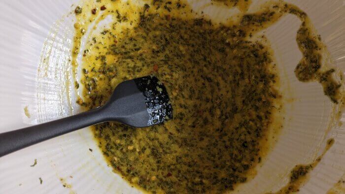 woman stirring a marinade with a black spatula