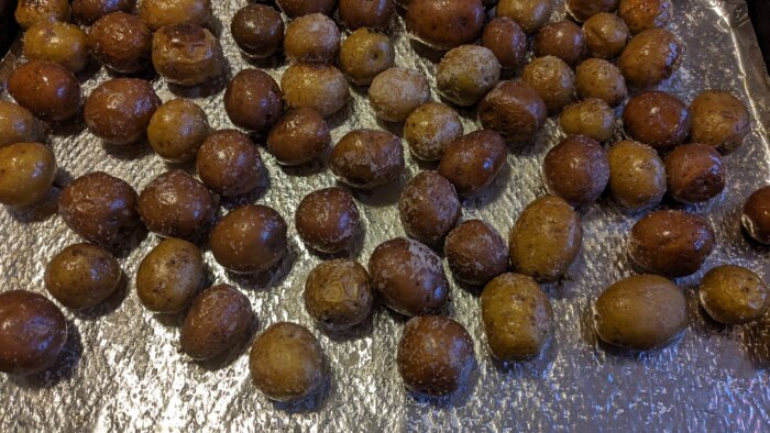 cooked baby potatoes on a tinfoil lined tray