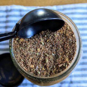 a tablespoon measurement above a jar of bulk homemade taco seasoning