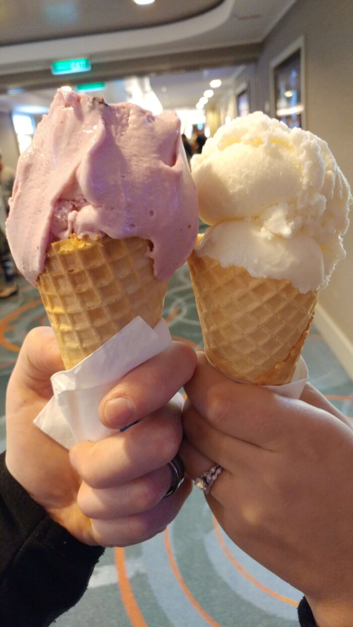 people holding two ice cream cones