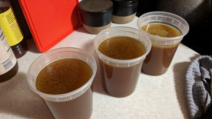 three containers of chicken stock