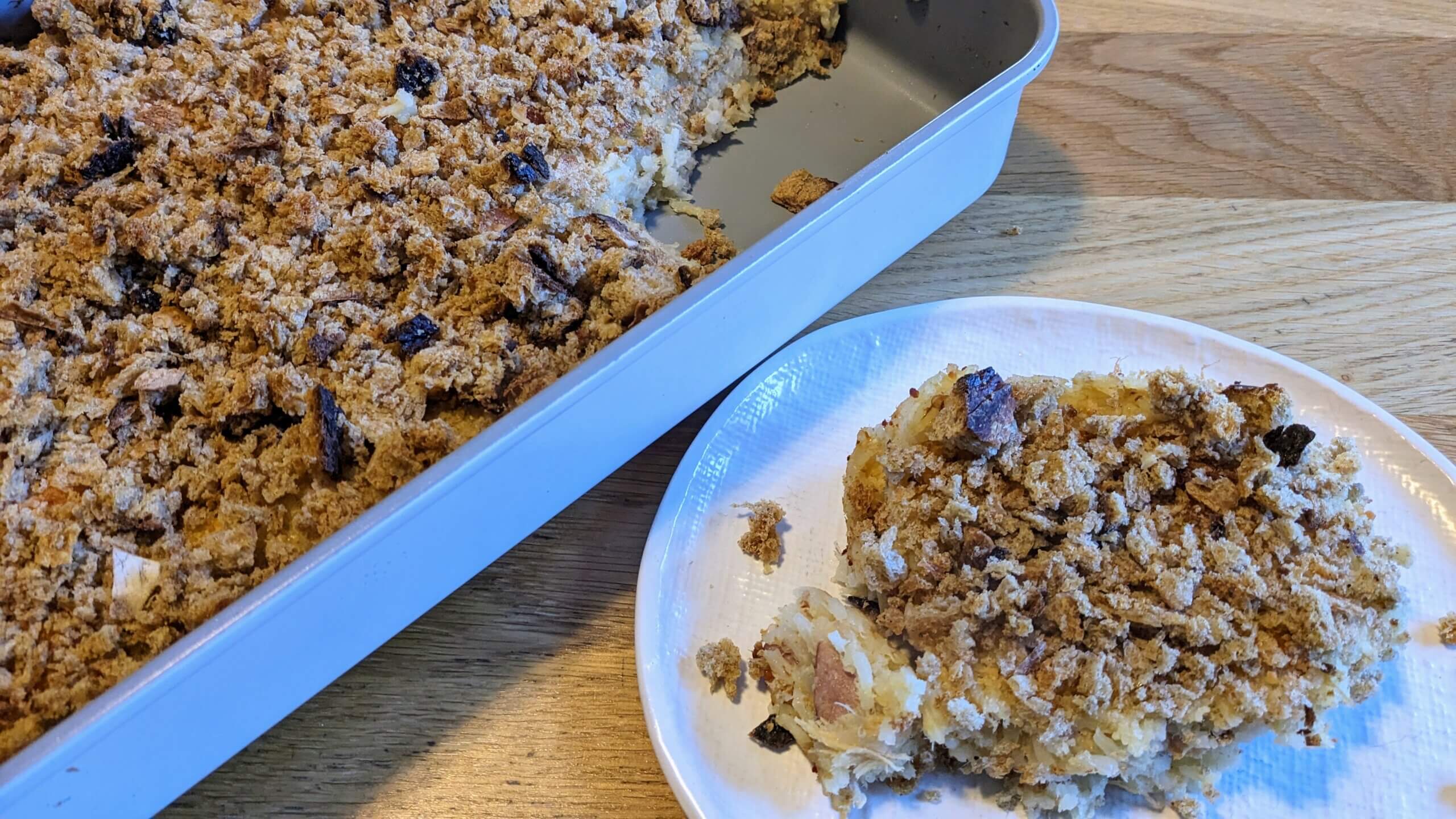 A plate of chicken Cordon bleu casserole next to a 9x13 casserole dish of chicken Cordon Bleu casserole