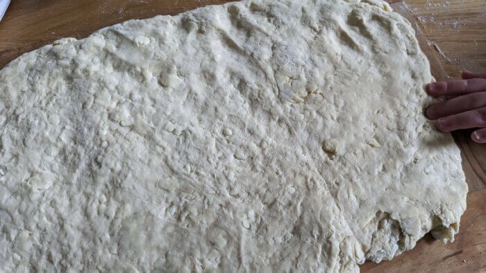 biscuit dough patted down to a half inch thick approximately to an approximate size of 9x13 inches