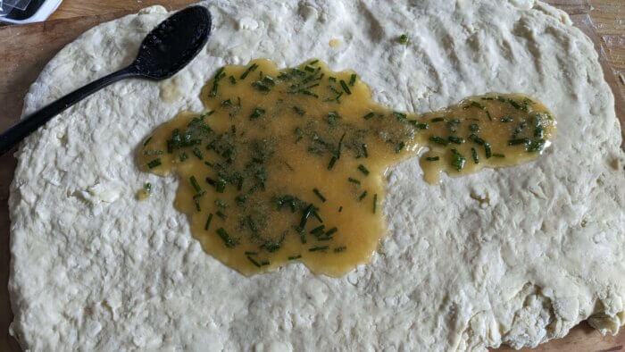 melted butter and herbs on biscuit dough