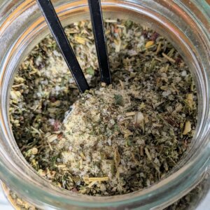 Homemade Bulk Italian Dressing Mix being scooped out of a mason jar