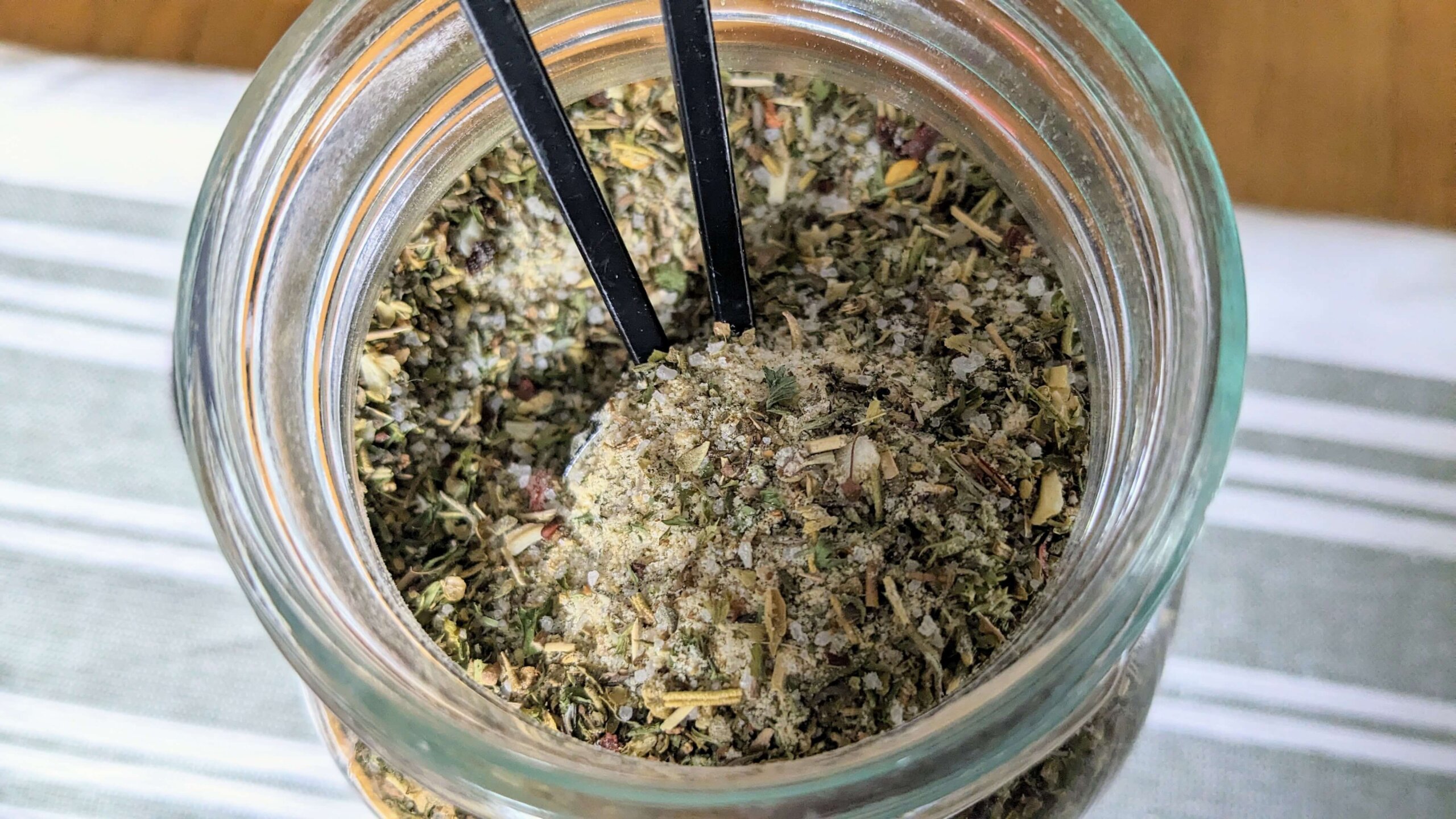 Homemade Bulk Italian Dressing Mix being scooped out of a mason jar