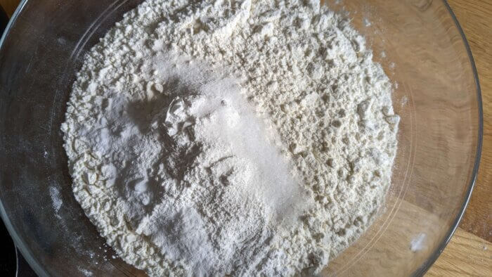 a bowl of dry ingredients for biscuits