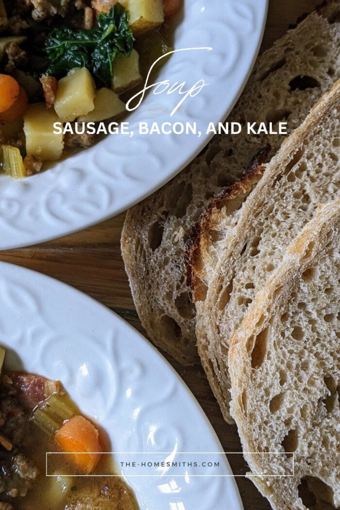 two bowls of sausage, Bacon, and Kale Soup next to sliced artisan sourdough bread