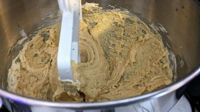 cookie dough batter being mixed in a kitchen aid