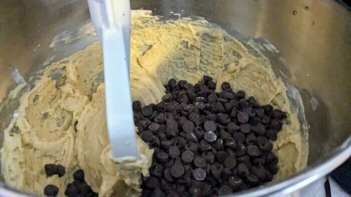 cookie dough batter and chocolate chips in a kitchen aid