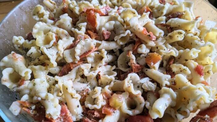 Cold Pasta salad with pepperoni, onions, tomatoes and cheese