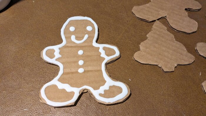 christmas themed cardboard cutouts of a gingerbread man decorated