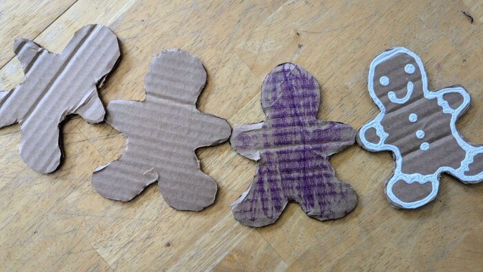 four gingerbread men cardboard cutouts