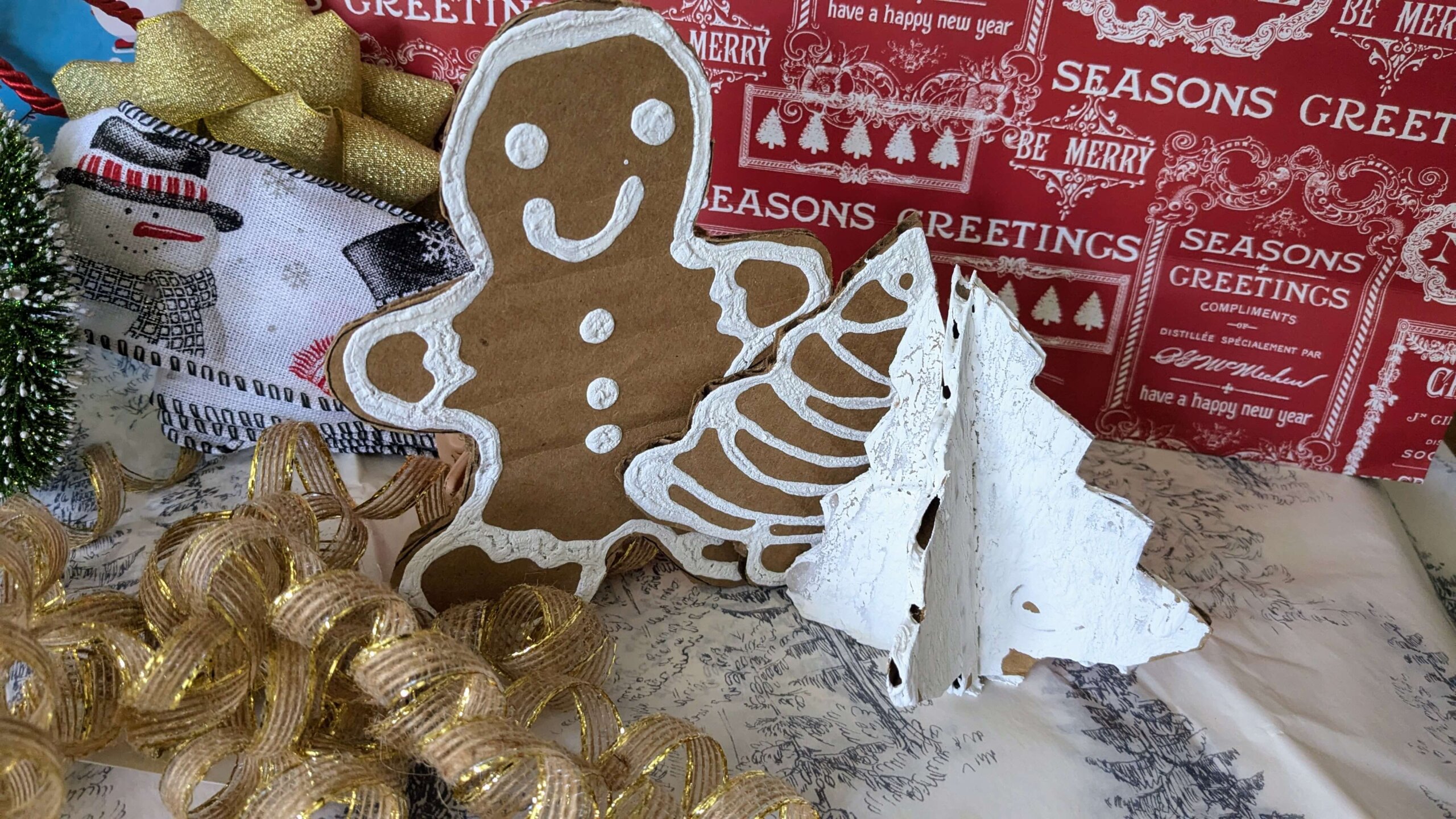 christmas themed cardboard cutouts of trees and gingerbread men decorated