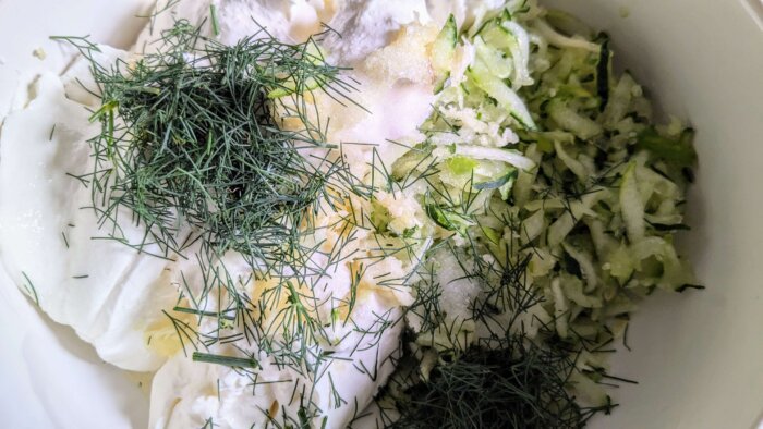 ingredients to make tzatziki sauce in a bowl